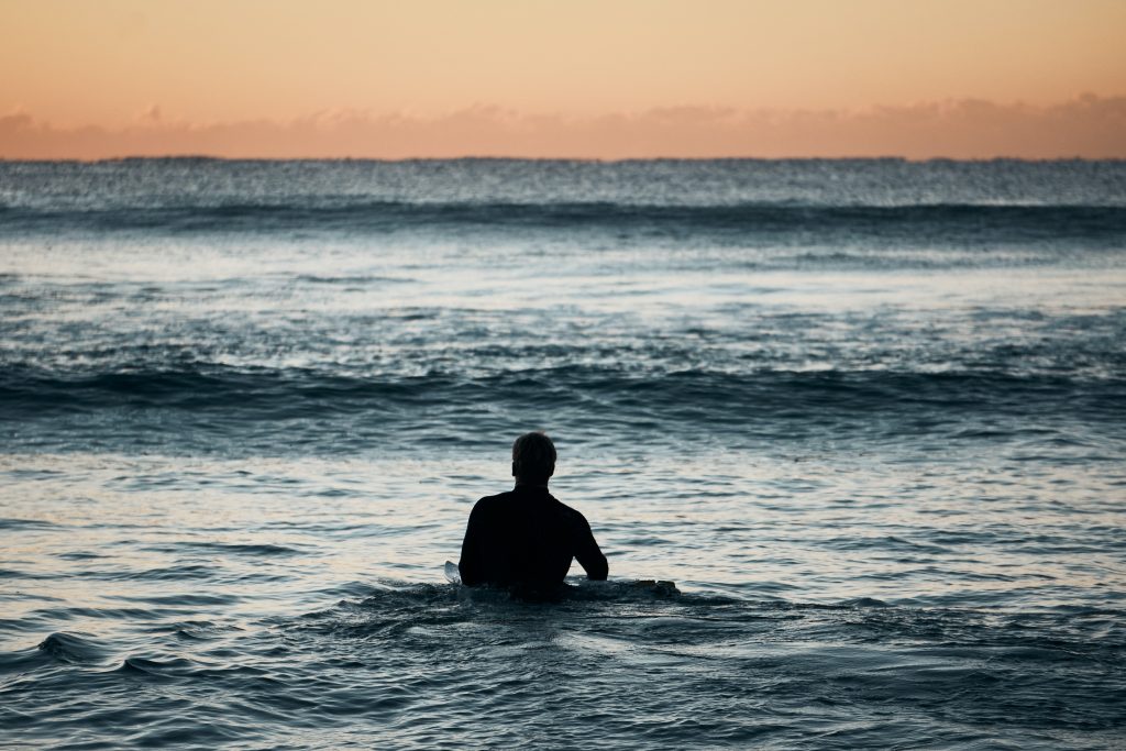surfer entering the ocean