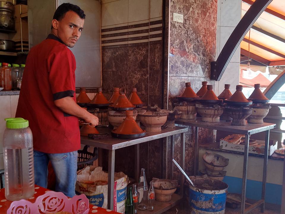 a man in the restaurant preparing Tagine