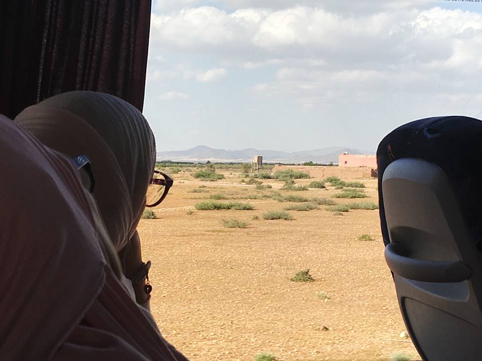 a women in burca looking out of the bus window