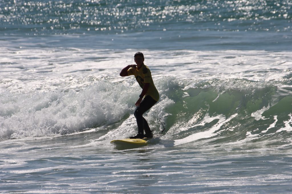 surfer girl on the wave showing to keep looking up